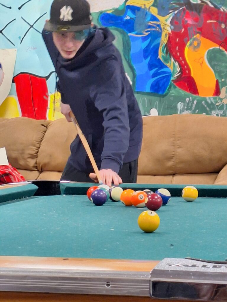 youth playing pool