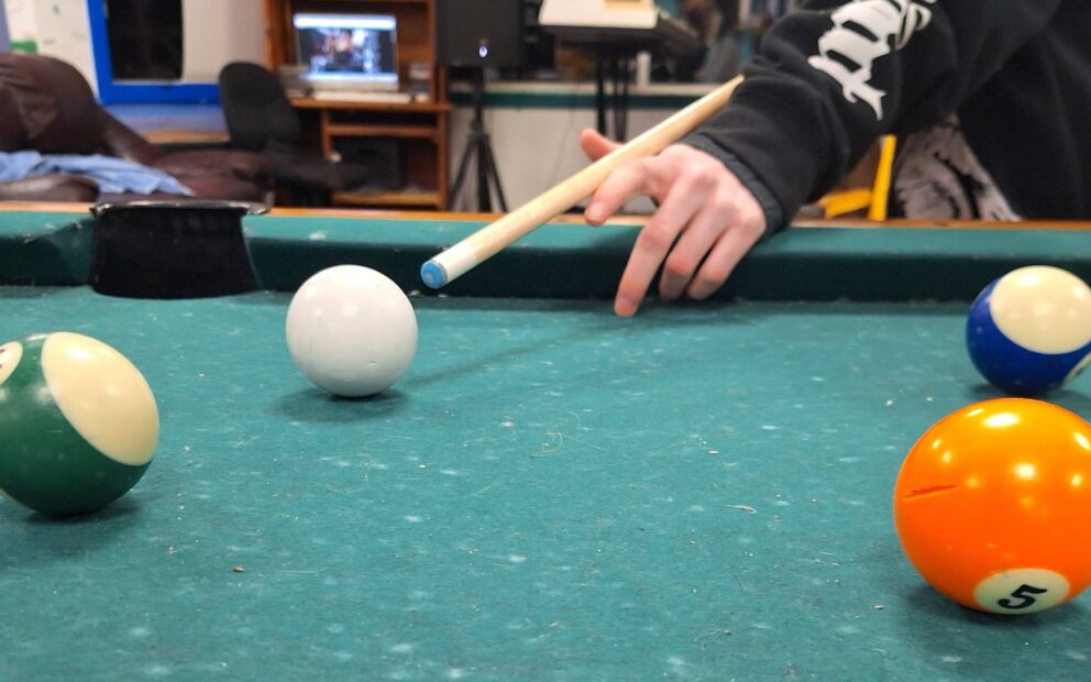 Youth playing pool